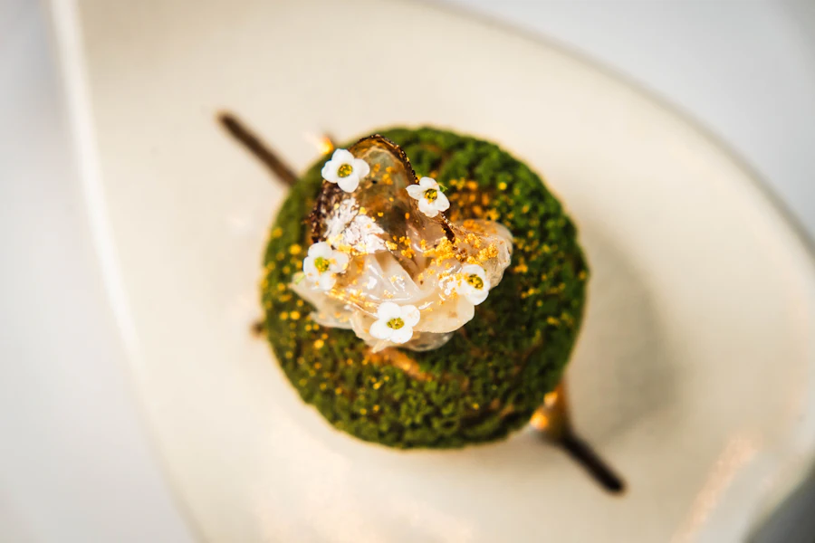 A green dessert with edible flowers