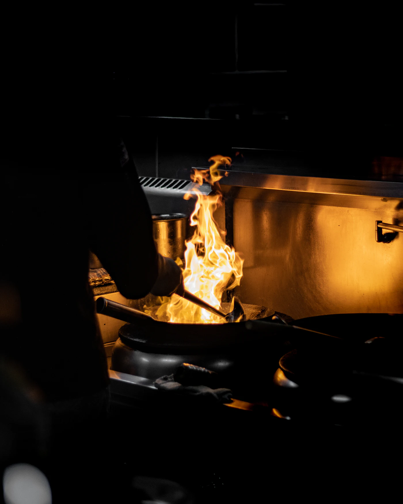 Food cooking over a grill in the dark