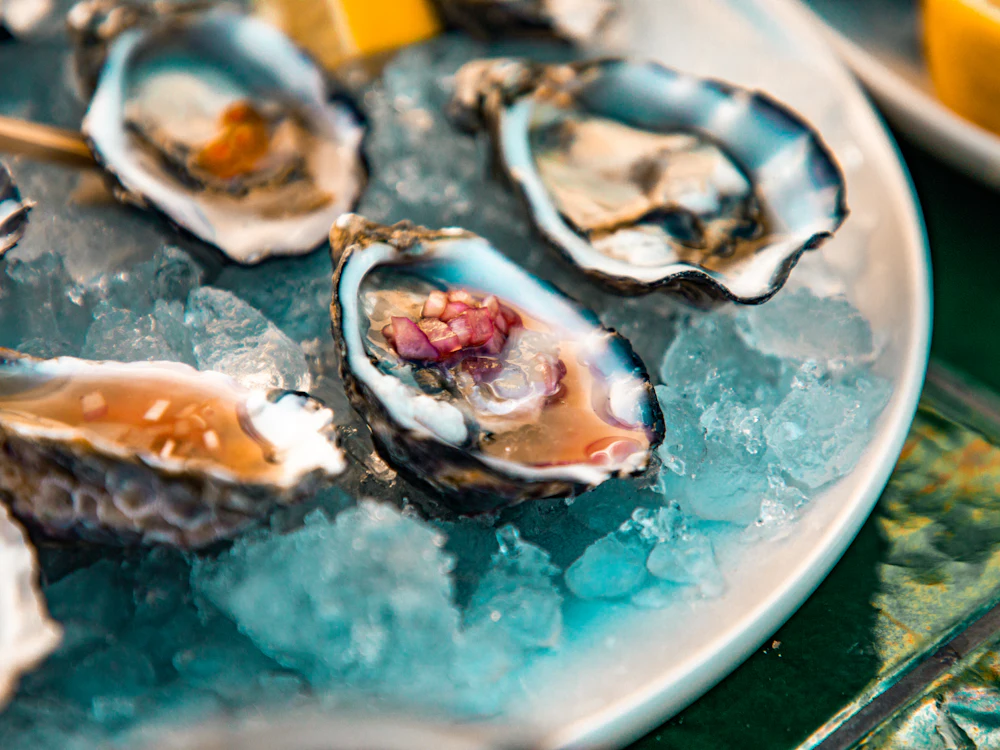 Oysters on ice with lemon wedges