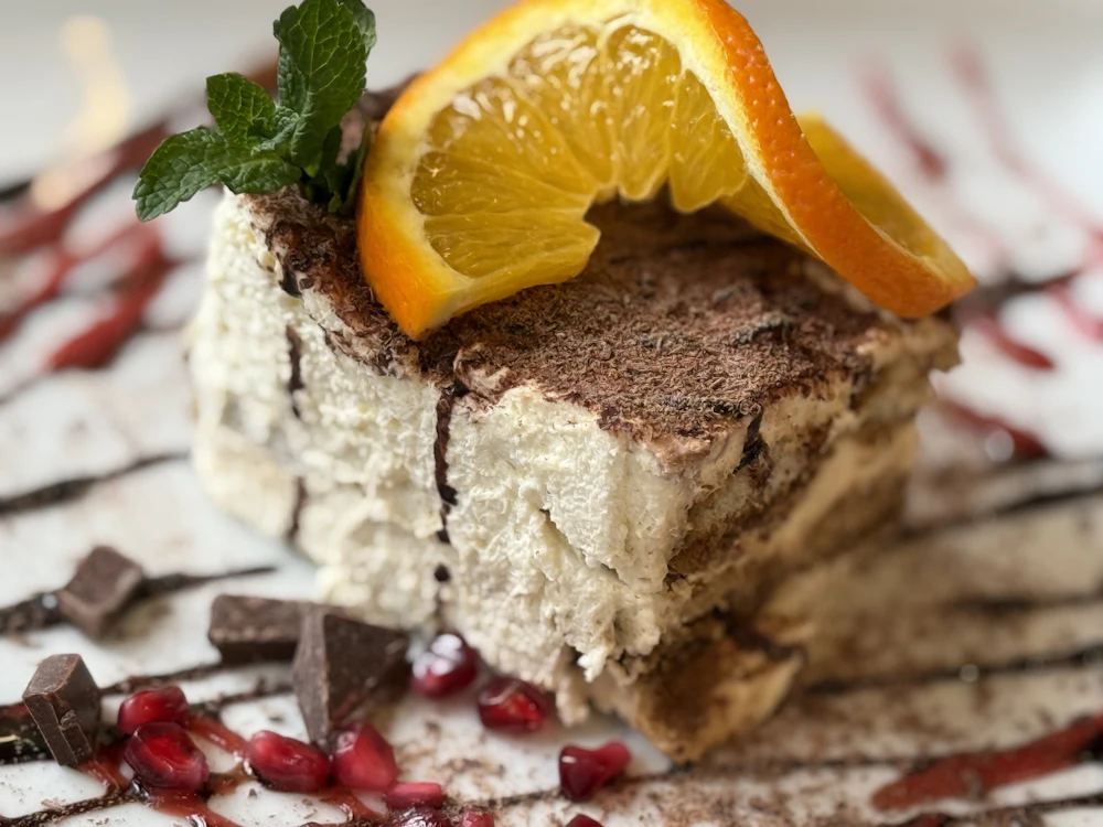 A plated dessert with orange and mint